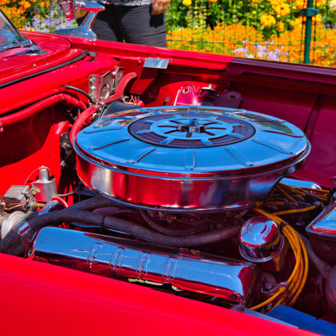 Baden-Baden, Germany - 10 July 2022: motor of red white second generation Ford Thunderbird aka Square Bird cabrio 1958, oldtimer meeting in Kurpark.