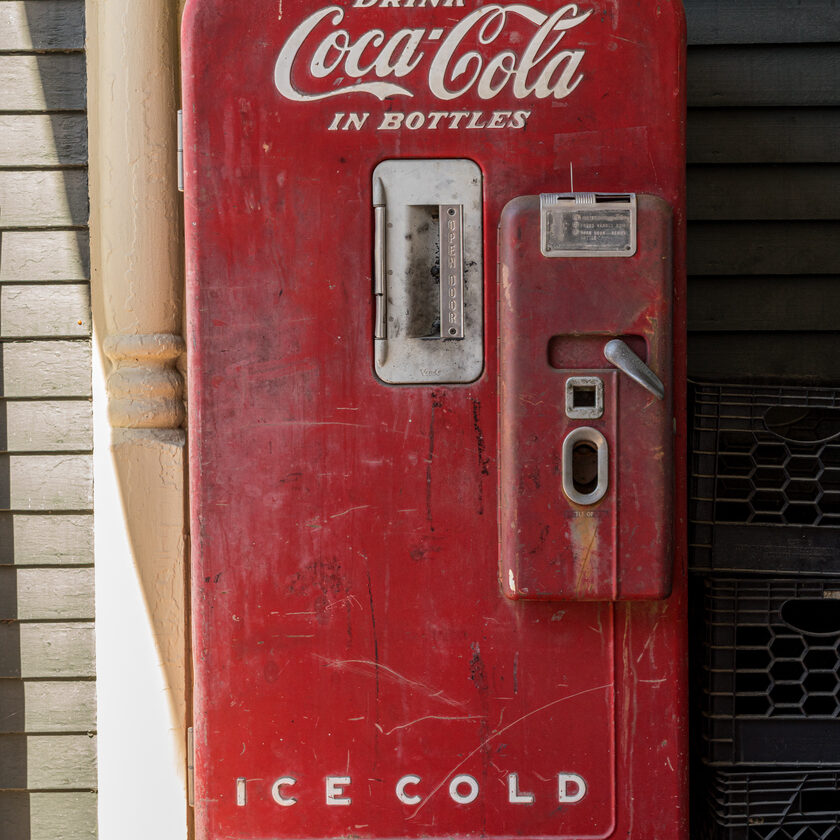 Stowe, VT - 6 October 2022: Antique refridgerated Coca Cola bottle dispenser